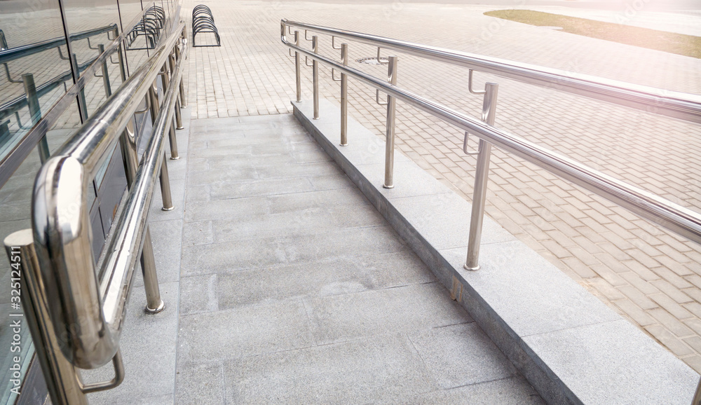 Ramp way with stainless steel handrail for support wheelchair disabled people infront of the entering the building. Ramp way with stainless steel handrail for support wheelchair disabled people infront of the entering the building.