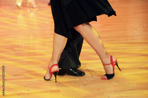 Graceful lines of legs of Argentina tango dancers