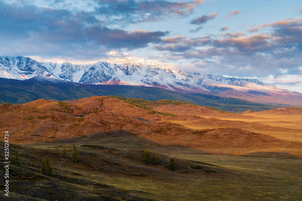 Morning in the Kurai steppe, the Moon over the North Chuysky ridge. Kosh-Agachsky District, Altai Republic, Russia