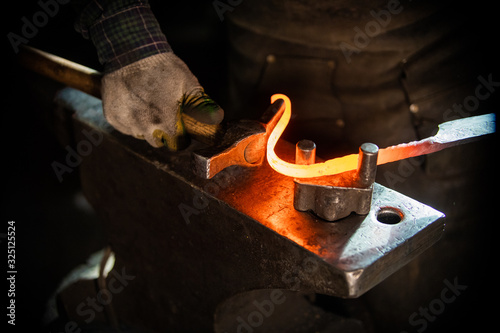 Quadro su tela A man blacksmith making a unique handle for the knife