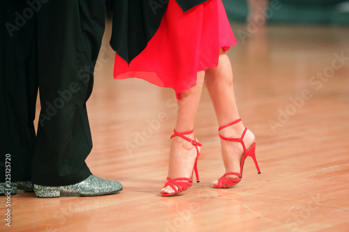 Beautiful woman in red dress dancing Argentinian tango 