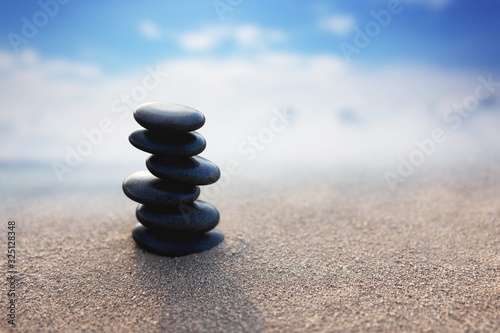 Balance stone with spa on blur beach and sea background