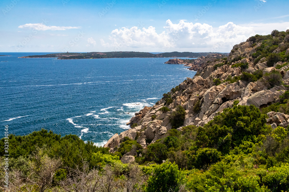 Sardinia: Colourful Granite Coastline, Mediterranean Ocean With Capo Ferro, Punta Battistone and Blue Sky – Baia Sardinia, Costa Smerelda, Sardinia, Italy.