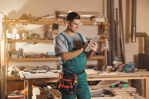 Принти на полотні Professional carpenter with tablet in modern workshop