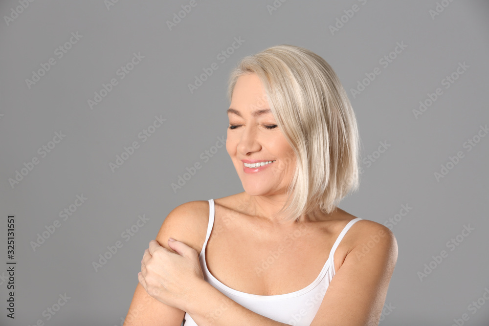 Portrait of beautiful mature woman on grey background Portrait of beautiful mature woman on grey background
