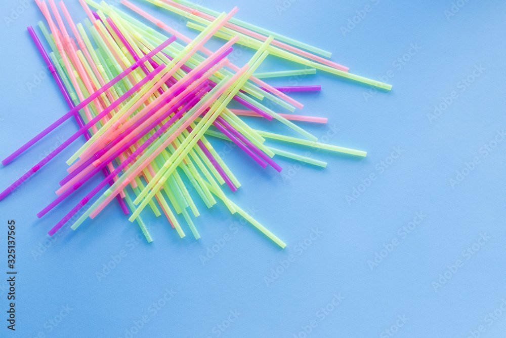 Colored plastic drinking straws on a blue background