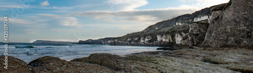 Panorama of white cliffs on Causeway Coast near Dunluce Castle, Northern Ireland