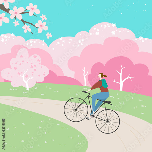 Park landscape with cherry blossom and girl on a bicycle.