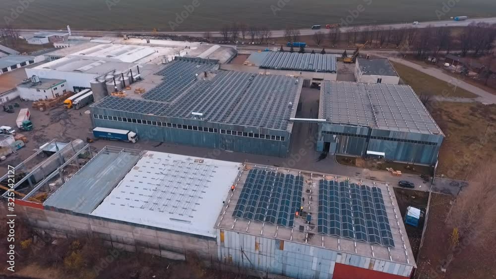 Solar farm on the roofs of buildings. Rooftops with many sunny batteries for receiving clean energy from sun. Aerial view. Solar farm on the roofs of buildings. Rooftops with many sunny batteries for receiving clean energy from sun. Aerial view.