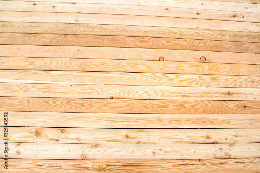 Fototapeta premium Background of light pine planed boards with knots and beautiful wood structure, texture design.
