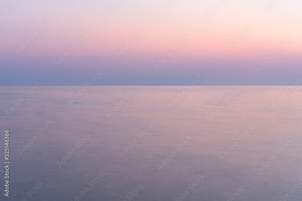 Sunset into the sea with twilight sky
