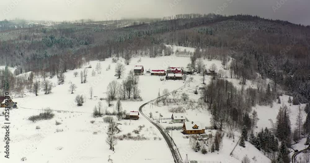 forest covered with snow aerial view. Aerial View of Village in Mountains forest covered with snow aerial view. Aerial View of Village in Mountains