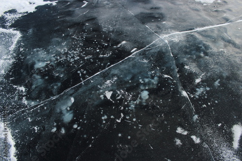 frozen lake, cracks on the surface. 