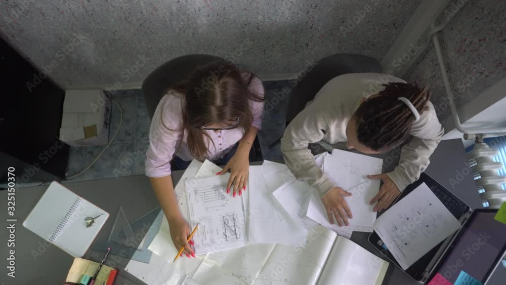 Two young persons are working in their creative office Two young persons are working in their creative office