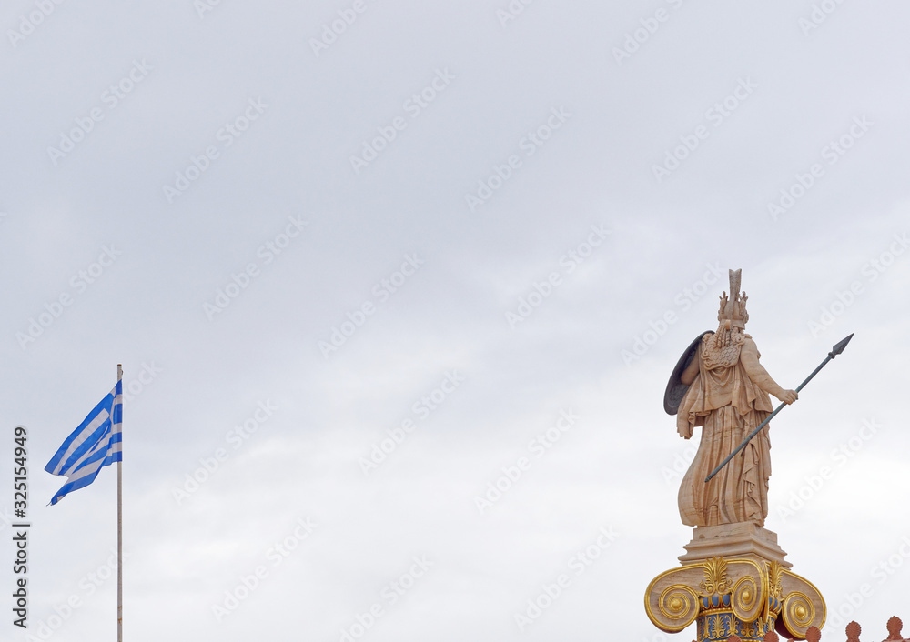 Athena the Greek goddess statue and blue white flag under cloudy sky