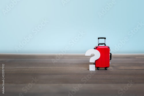 Question mark with Red Luggage Bag on wood table , Problem Concept