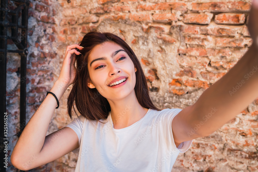 Latin woman taking a selfie. Latin woman taking a selfie.