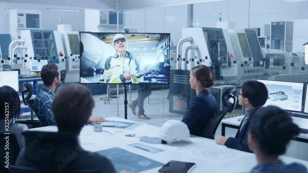 Diverse Group of Specialists, Managers in the Factory Office Meeting Room, Have Conference Video Call with Factory Chief Female Engineer, She Talks about Production Growth, Uses Tablet Computer