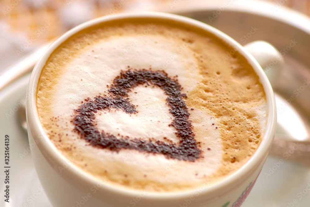 cup of strong coffee cappuccino with milk foam and heart of cinnamon
