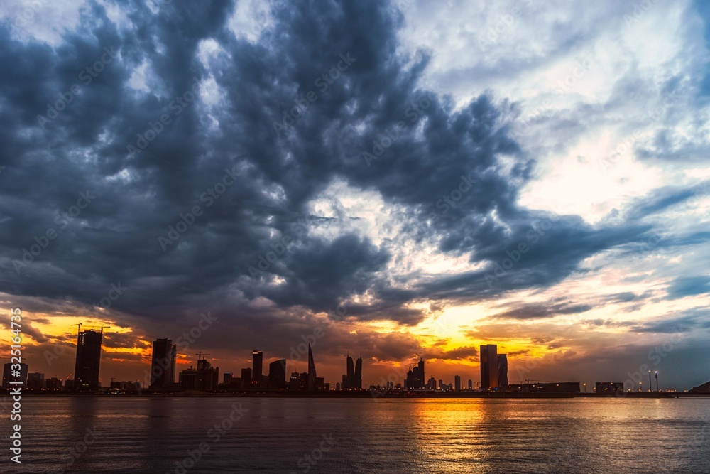dramatic sky at sunset over water front in Bahrain