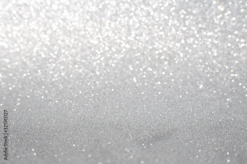 Defocused abstract silver, white, grey lights background. Space. Wallpaper. Abstract glitter bokeh