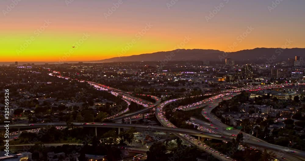 Los Angeles Aerial v227 Slow panning view of Santa Monica and San Diego Freeway cityscape at sunset, dusk with small plane - October 2019