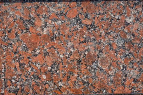 Granite surface in orange, gray, white, black mix. Copy space. Minimalism. 