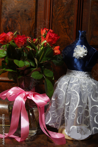 Red roses bouqet on the vintage old wooden piano