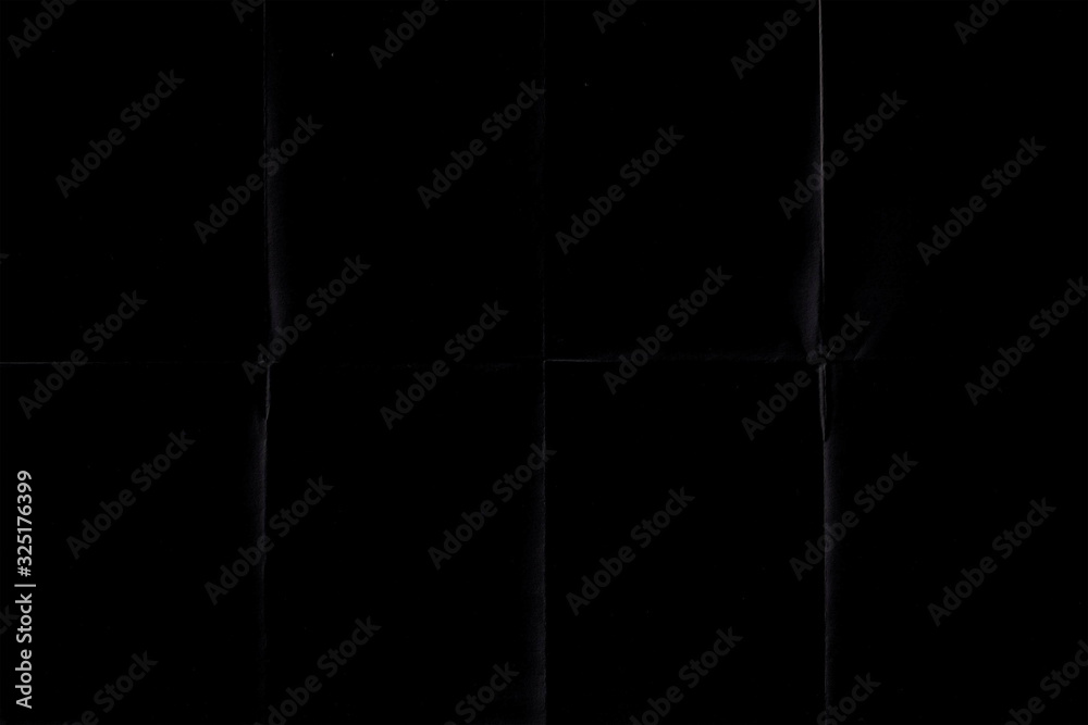 Naklejka premium black crumpled paper texture with folds, black background, wallpaper.