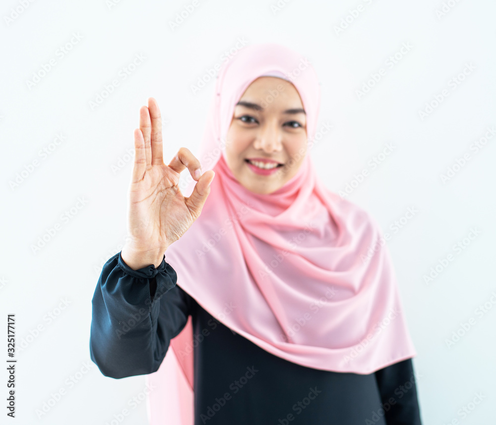 Beautiful female Muslim model in modern kurung and hijab, a modern lifestyle apparel for Muslim women isolated on white background. Beauty and hijab fashion concept. Half length portrait Beautiful female Muslim model in modern kurung and hijab, a modern lifestyle apparel for Muslim women isolated on white background. Beauty and hijab fashion concept. Half length portrait