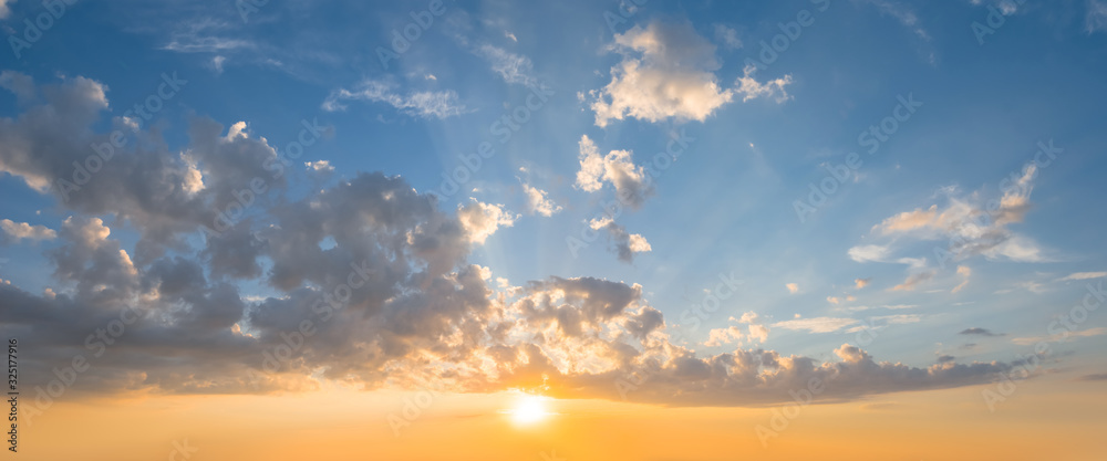 Fototapeta premium dramatic sunset over a cloudy sky, evening outdoor background