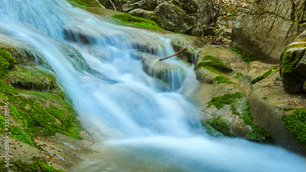beautiful closeup waterfall on a mountain river