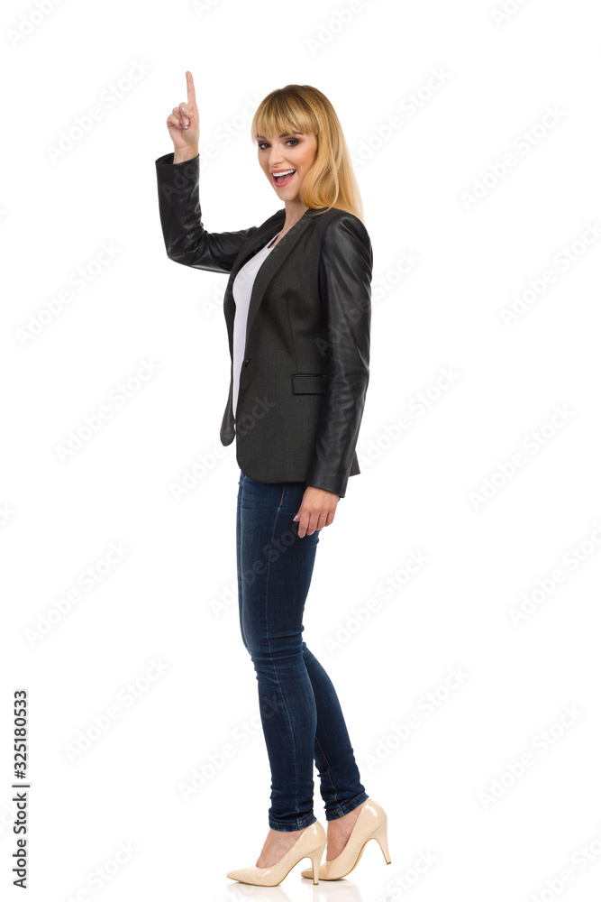 Young Businesswoman Is Standing With Arm Raised, Pointing Up And Talking Young Businesswoman Is Standing With Arm Raised, Pointing Up And Talking