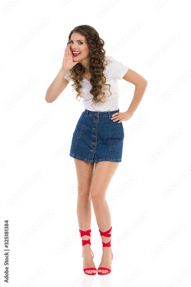 Young Woman In Jeans Mini Skirt And Red High Heels Is Shouting And Smiling