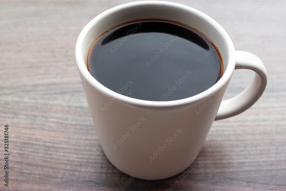 coffee mug standing outside on a wooden surface coffee mug standing outside on a wooden surface
