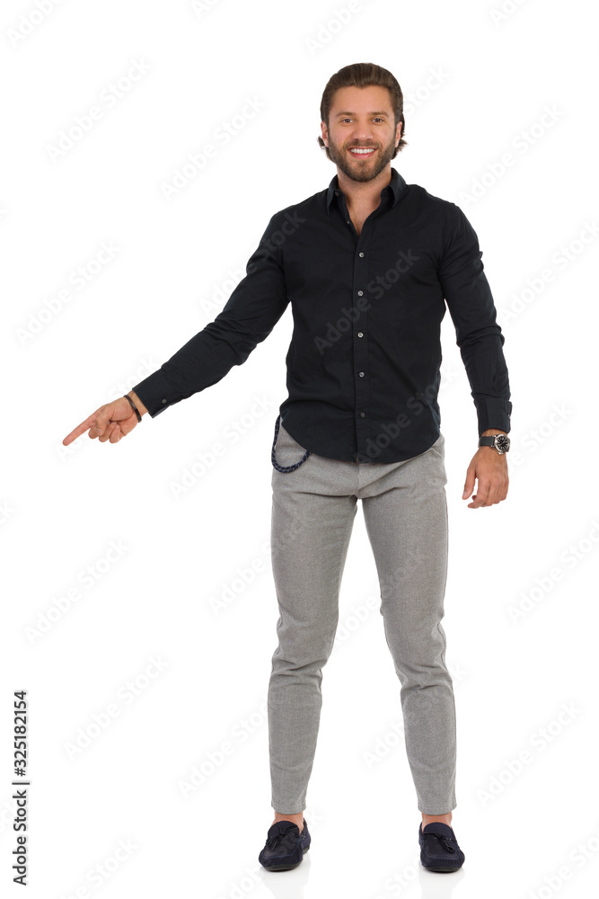 young man standing with his hands in pockets young man standing with his hands in pockets