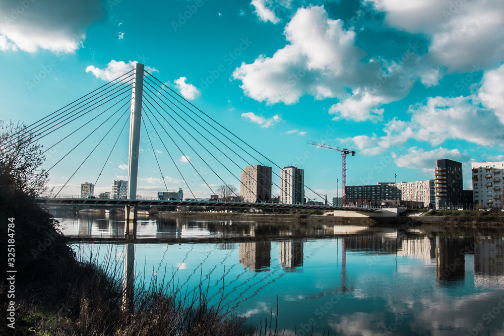 Fototapeta premium Reflection of a bridge over the Loire river in Nantes