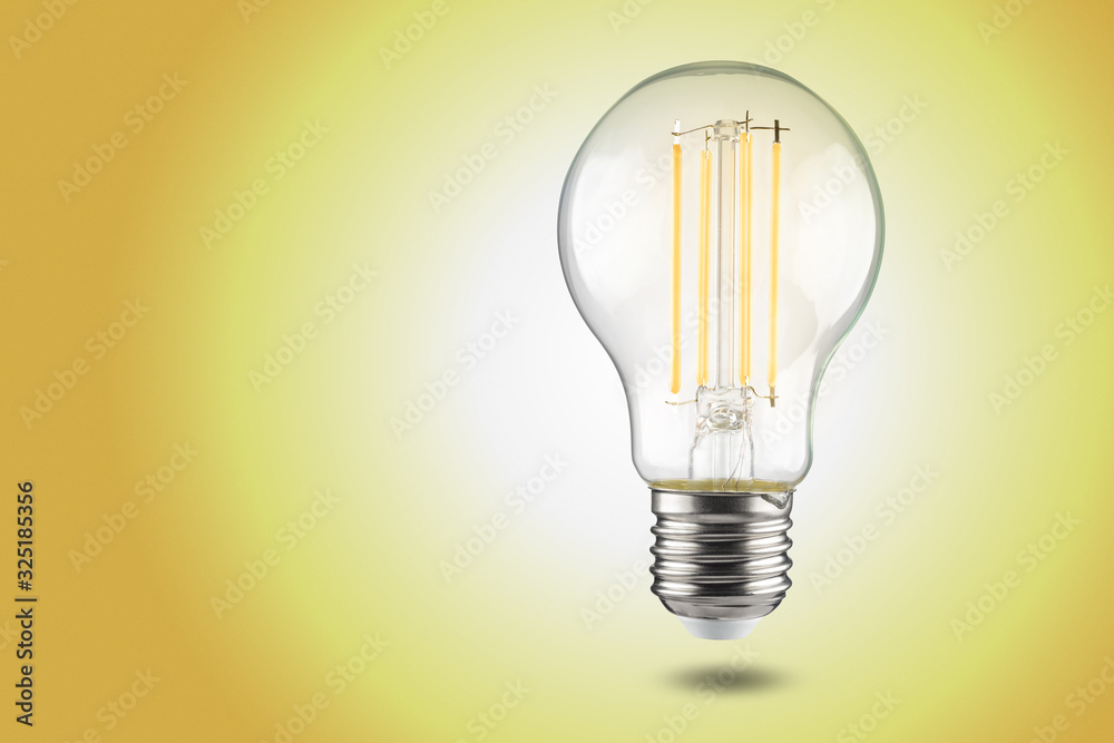 filament LED light bulb bulb with e27 cap on a yellow background. filament LED light bulb bulb with e27 cap on a yellow background.