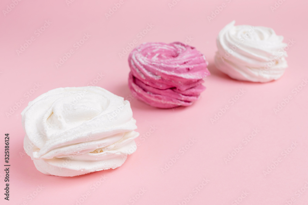 Fresh vanilla and berry marshmallows on a pastel pink background. The concept of home-cooked food, sweets. Minimalism, top view, flat lay, copyspace.