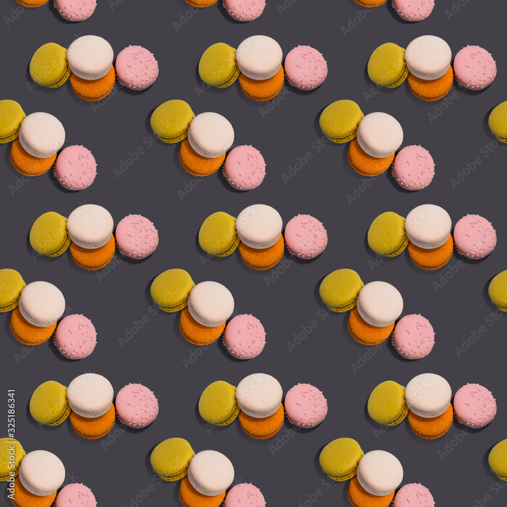 Fototapeta premium Seamless pattern heap of four multi-colored macaroon on dark background