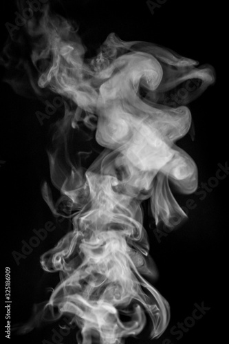 Smoke or steam on black isolated background for insertion image in overlay mode_