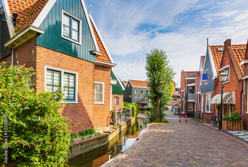 Old streets in Volendam, old traditional fishing village, typical wooden houses architecture