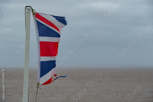 Torn English flag fluttering in the wind