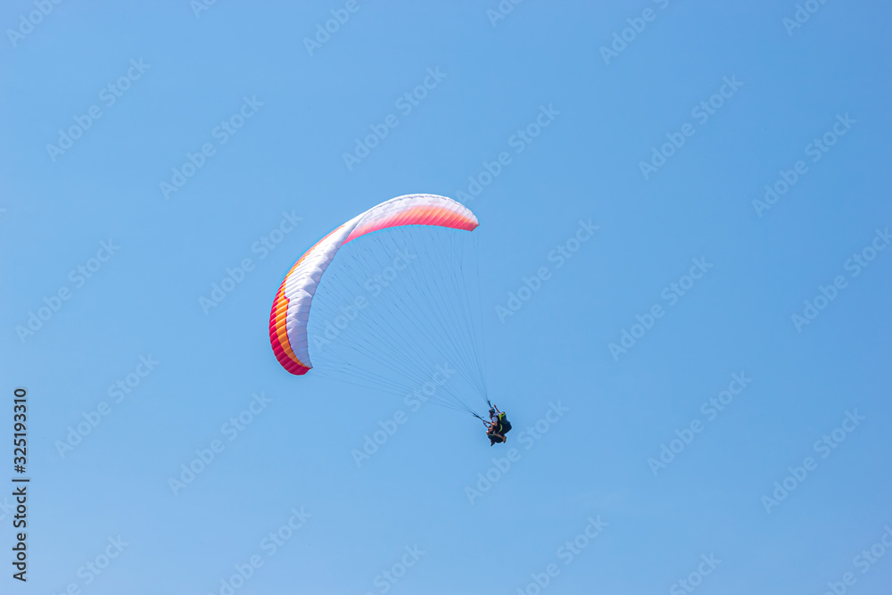 Paraglider is flying in the sky. sunny day Paraglider is flying in the sky. sunny day