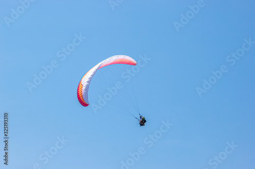 Paraglider is flying in the sky. sunny day