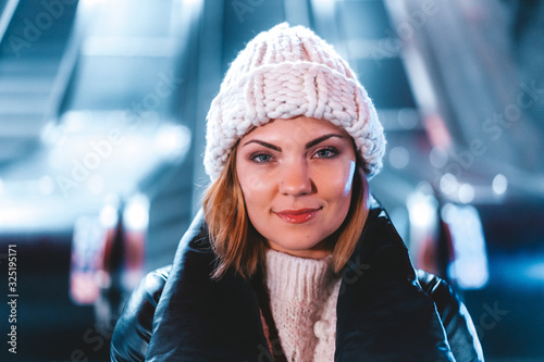 Portrait of woman in winter clothing at subway station. Underground in Stockholm.