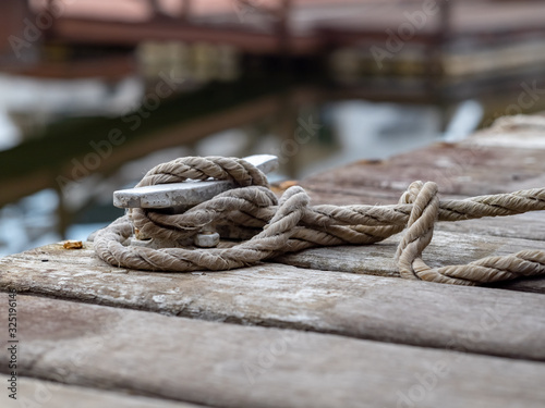 Rope tied to the mooring cleat on wooden pier, Angra dos Reis, State of Rio de Janeiro, Brazil
