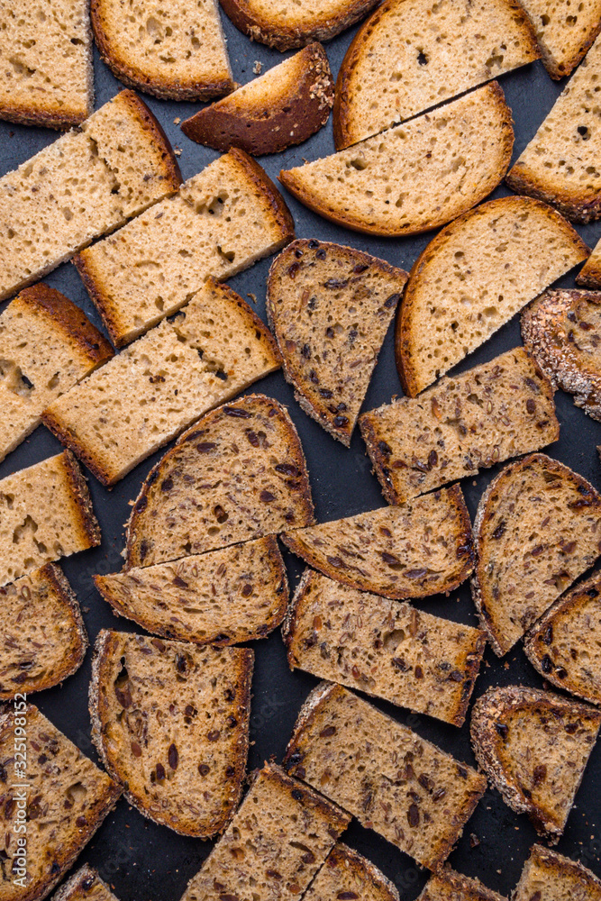 Brown bread croutons with seeds background Brown bread croutons with seeds background