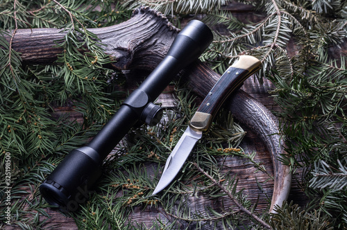 Hunting knife and scope. Hunting things. Hunting still life. photo