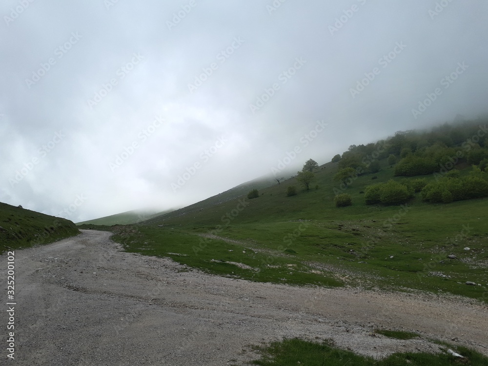 Old mountain road covered with clouds in early morning Old mountain road covered with clouds in early morning